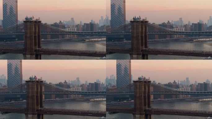 清晨黎明时分，近距离鸟瞰布鲁克林大桥塔顶的美国国旗，背景是曼哈顿天际线的远景。无人机视频与缓慢摇摄相