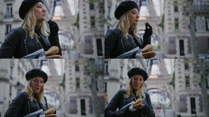 时尚的法国女人在埃菲尔铁塔边的大街上吃法棍面包