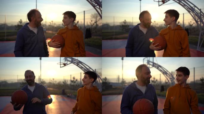 少年男孩在篮球场上和父亲一起享受时光
