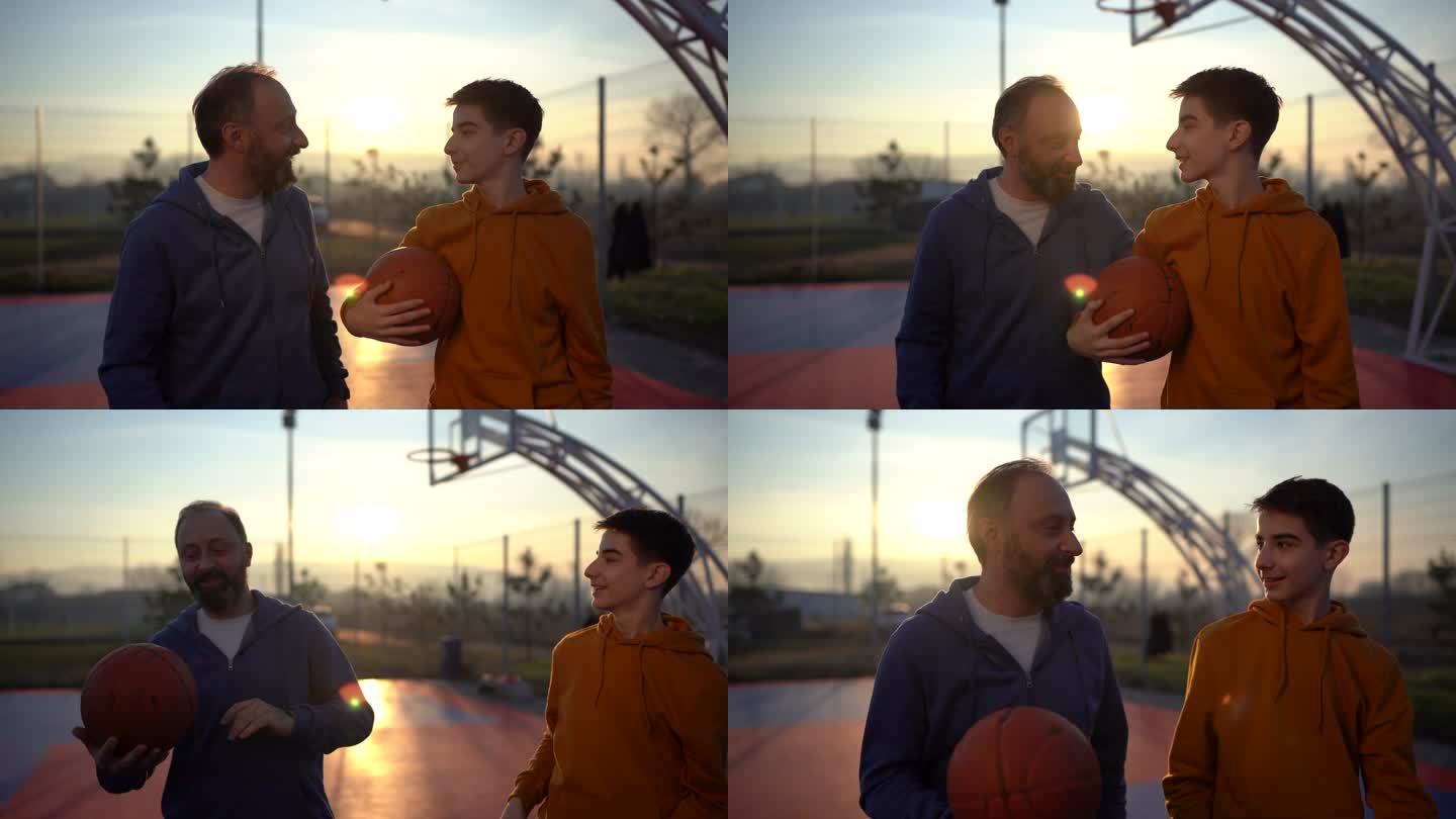 少年男孩在篮球场上和父亲一起享受时光