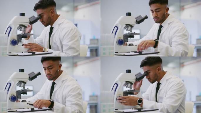 科学家看着显微镜并写下发现。实验室里的西班牙裔男性研究员男技术员分析数据