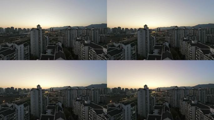 城市居民区的高角度视图，从白天到黄昏的延时摄影都有灯光效果。