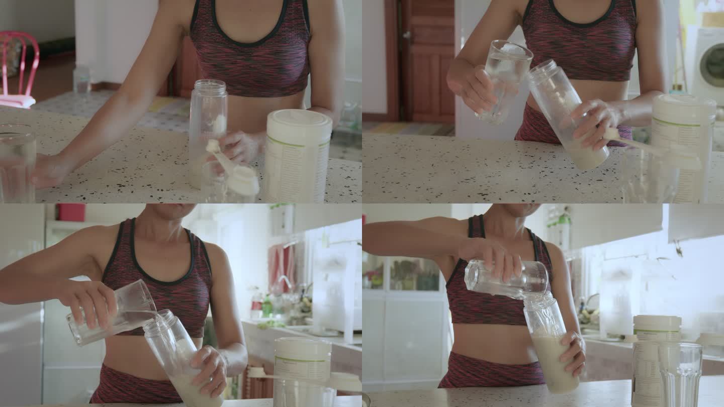 穿着运动服的亚洲年轻女性在家里的厨房里用蛋白粉制作奶昔。