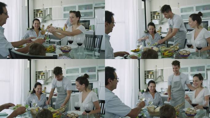 年轻的成年男子坐在餐桌旁为家人提供健康食品