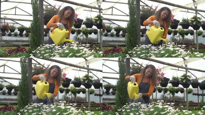 快乐的女园丁在花园中心为植物浇水