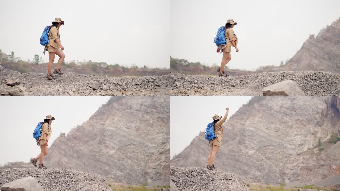 年轻的亚洲女背包客，背着背包沿着大峡谷地区徒步旅行，爬上山顶，一边休息一边环顾四周，热带气候地区，享