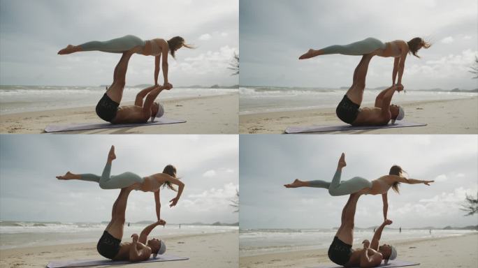 一对穿着运动服的白人年轻夫妇在沙滩上一起做健身运动和练习瑜伽