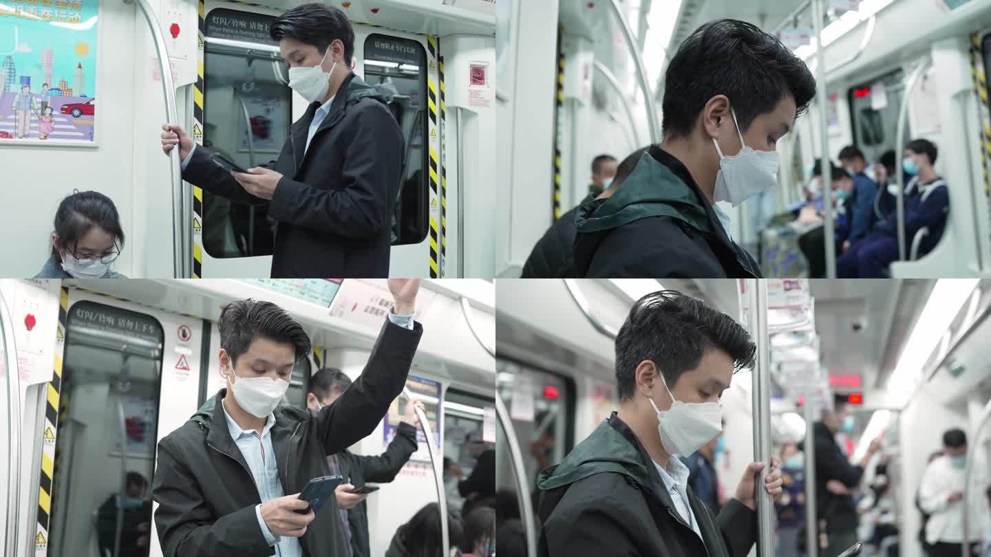 都市男士地铁里低头看手机玩手机