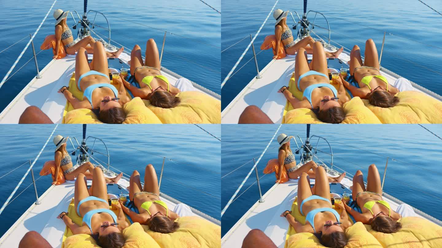SLO MO LD三名女子在海上游艇上晒日光浴