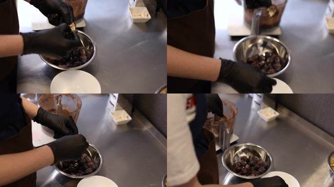 一位面目全非的糕点厨师将椰枣放入搅拌机中切碎，制成蛋糕馅料