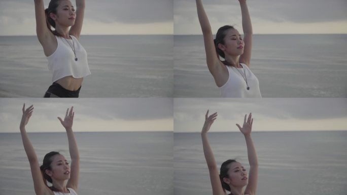 一位千禧一代女性在沙滩上户外练习瑜伽的中镜头