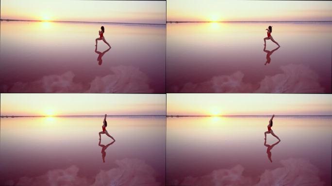 乌克兰粉红色盐湖上做瑜伽的女人