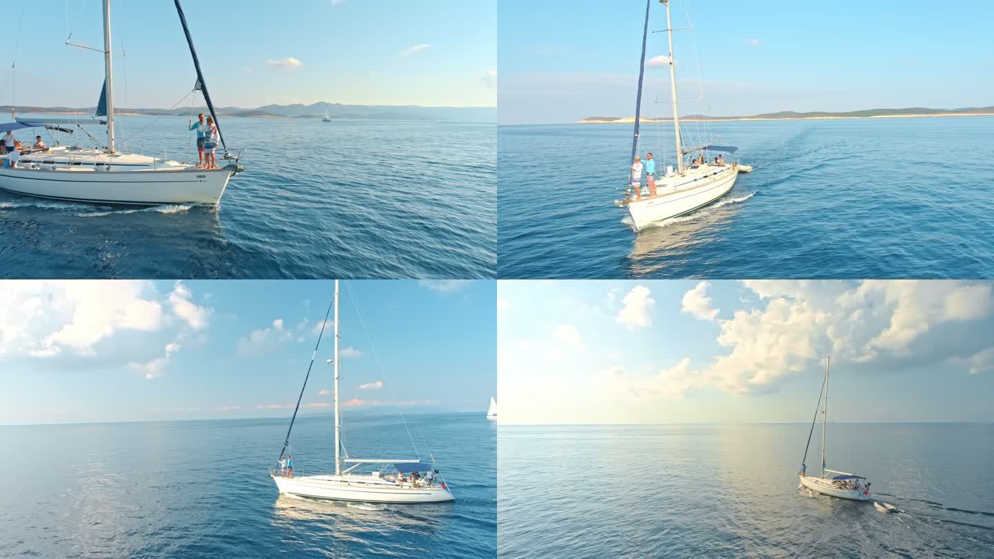 4K无人机视点朋友在宁静、阳光明媚的蓝海上的帆船上，实时