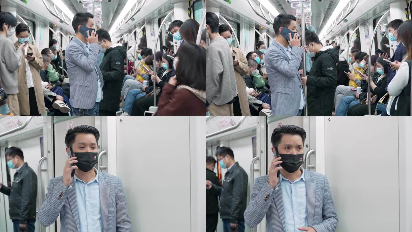 都市男士在地铁车厢手机打电话接电话
