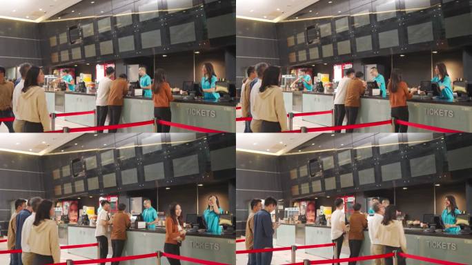后视图亚裔华人在电影院排队购买电影票和快餐