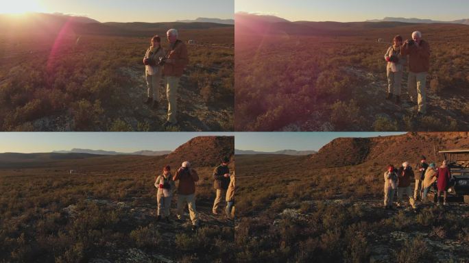 一对老年夫妇在阳光明媚的偏远地区与旅行团一起进行狩猎旅行