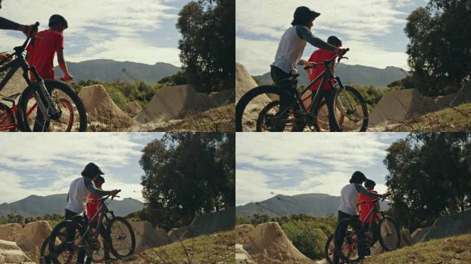 两名年轻的男性BMX自行车骑手，一边步行，一边将自行车推到泥土跑道上的坡道上，一边练习，为即将到来的