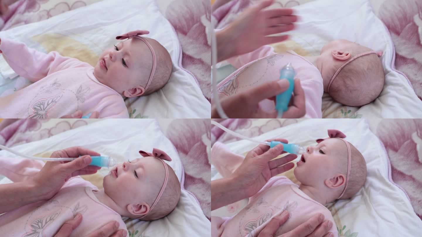 母亲用鼻吸器从婴儿身上吸鼻涕。