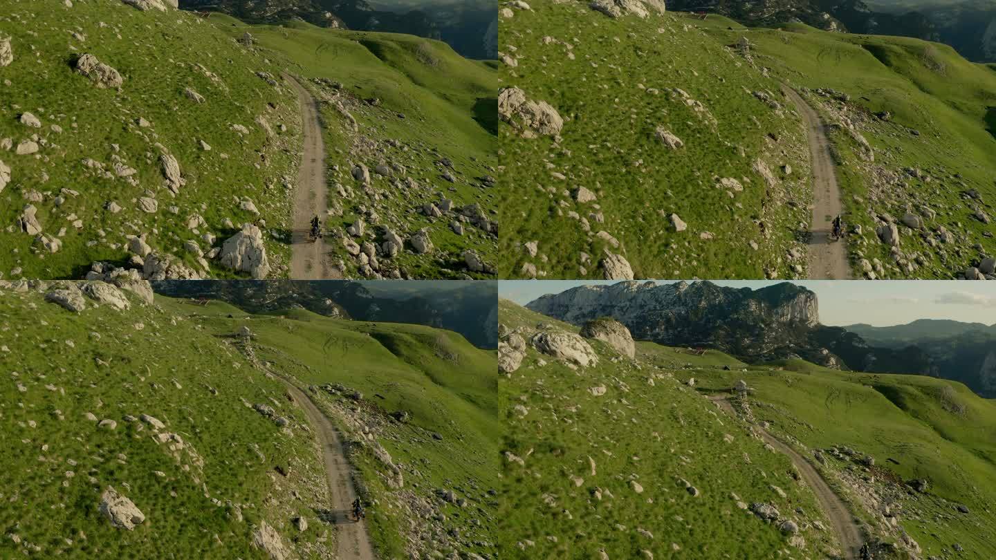 无人机拍摄的摩托车手在山上越野