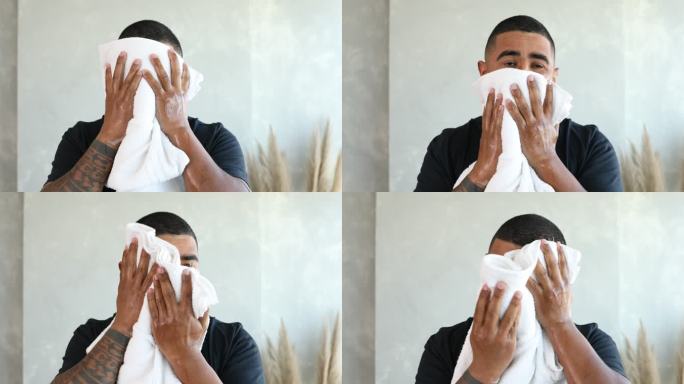 成年男子用毛巾擦干脸