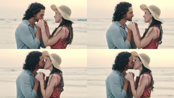 一对幸福的年轻情侣相爱，订婚后在海滩上拥抱。无忧无虑的男女在求婚后充满喜悦，亲吻并分享浪漫时刻