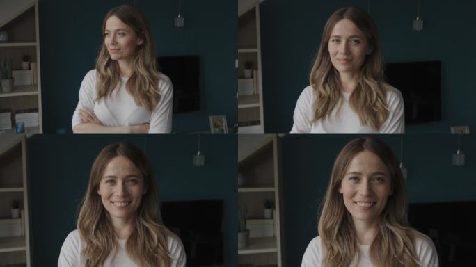 视频中，一位快乐的年轻女子双手交叉站立，对着镜头微笑