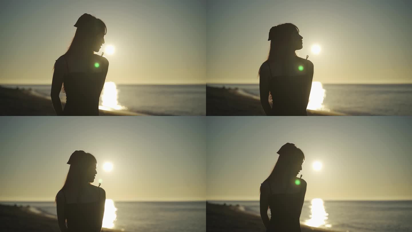 阳光下美女走向海边沙滩上漫步走路女人背影