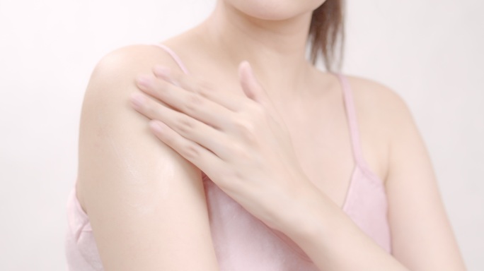 亚洲成年女性用手在肩上涂抹保湿霜。身体护理理念。