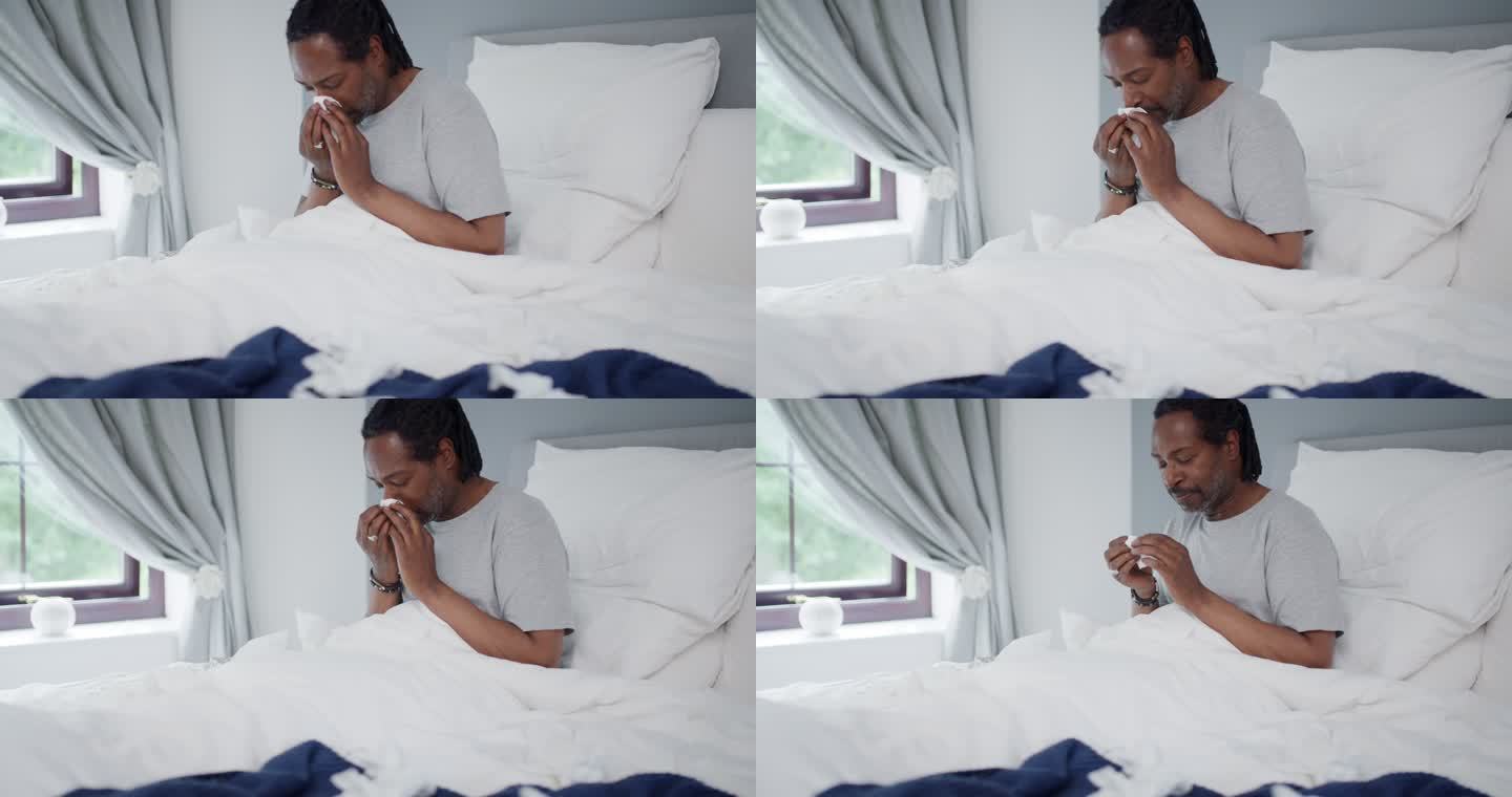 一名患有流感的成年男子在家中床上擤鼻涕的4k视频片段