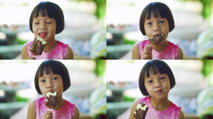 可爱的女孩正以积极的情绪吃巧克力冰淇淋零食，放松心情，享受美食。