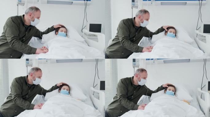 生病的小女孩躺在病床上，她的父亲在她身边担心和祈祷。充满希望的情感和精神时刻