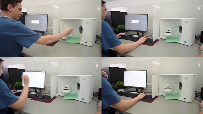 男性技术人员使用计算机程序打印3D下颌