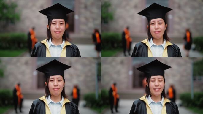 校园里穿着毕业礼服的亚洲女大学生肖像
