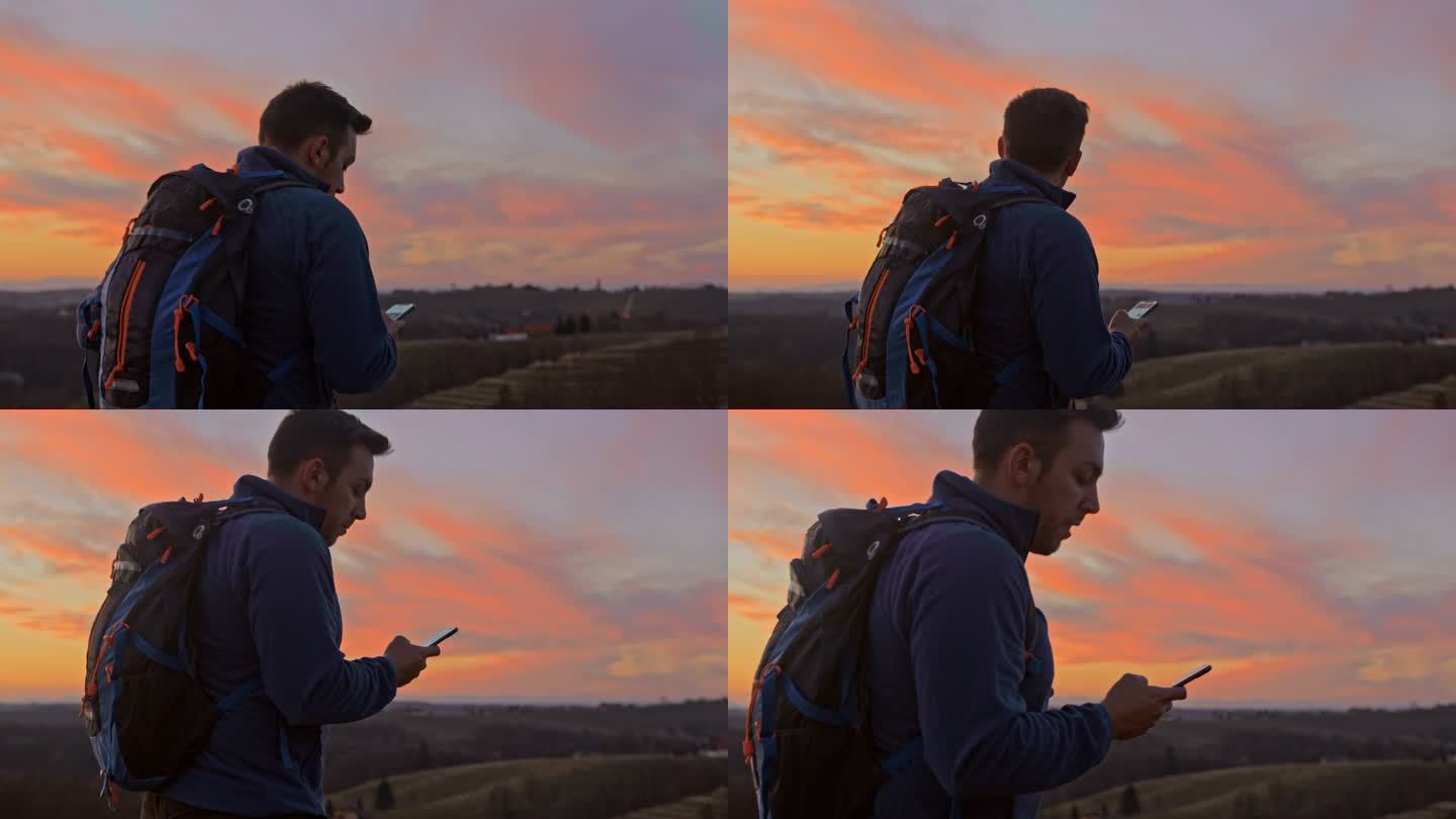 男子用手机在山景上指路