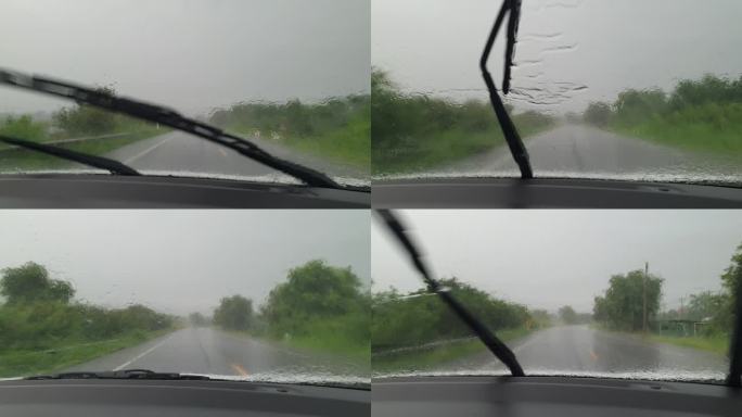 开车和雨滴在挡风玻璃上。
