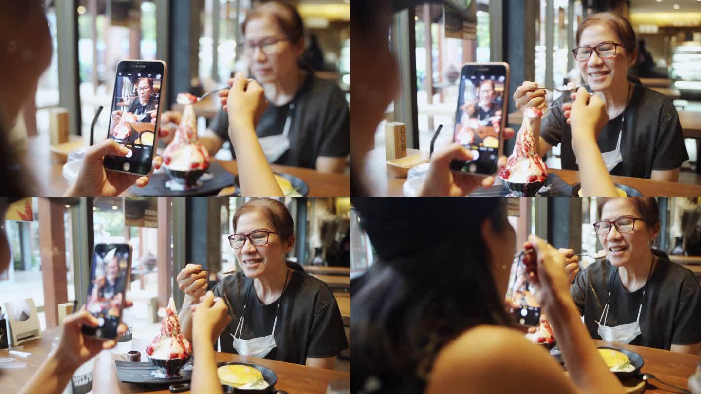 亚洲女人吃着冰糖甜点，满脸笑容地拍照。