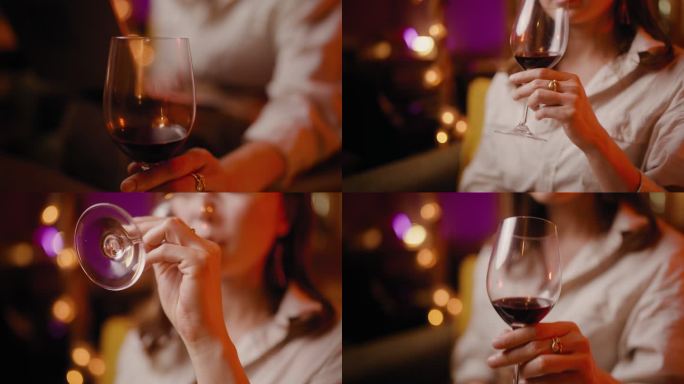 一位女士在舒适的咖啡馆和酒吧里使用笔记本电脑享受红酒的特写镜头