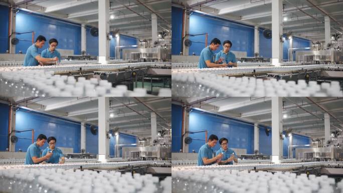 亚裔中国检查员在制造厂水灌装厂展示新员工