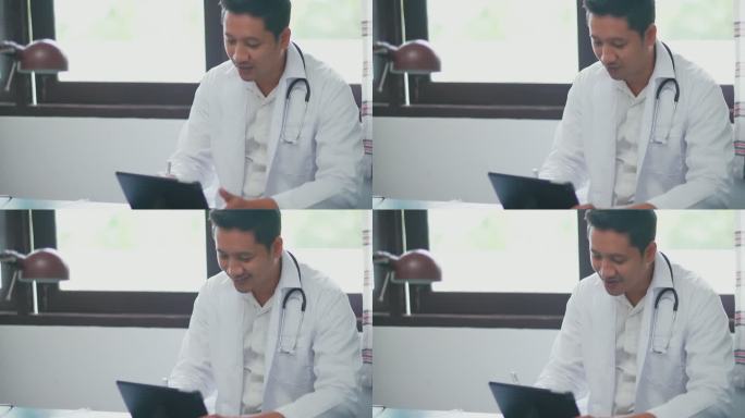 坐在办公室里的特写医生通过视频通话与他的一名患者交谈。