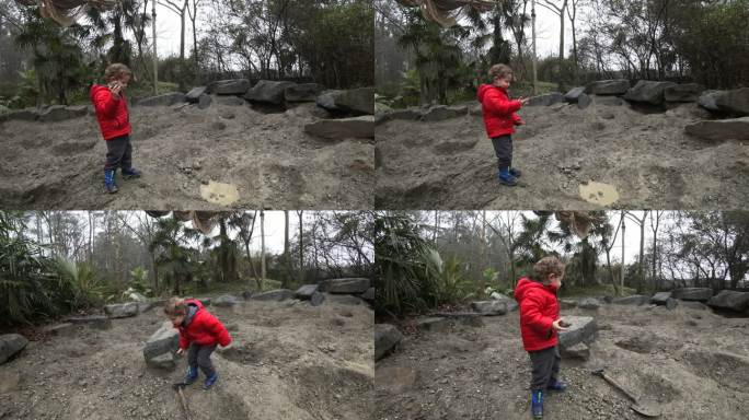 小男孩在泥泞的沙坑里玩耍