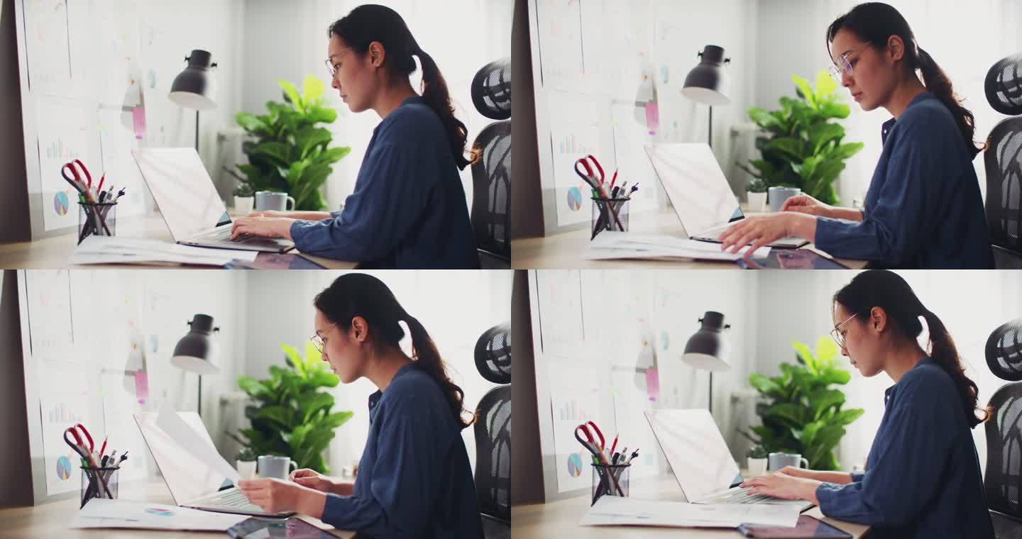 在办公室使用笔记本电脑的亚洲女商人