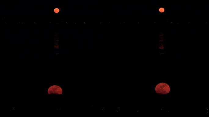 夜晚城市上空红月亮实拍