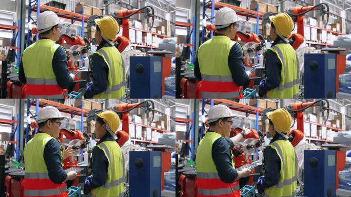 戴着白头盔的亚裔男子向新员工解释仓库中使用的机器。