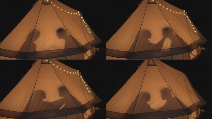 快乐的亚洲情侣在帐篷里露营度假。