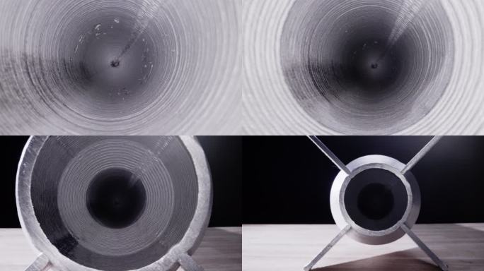 室内制造设施中的铝制3D打印同心圆管状物体的拉出镜头