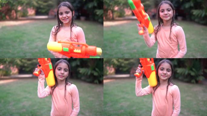 一个女孩在后院玩喷枪的肖像