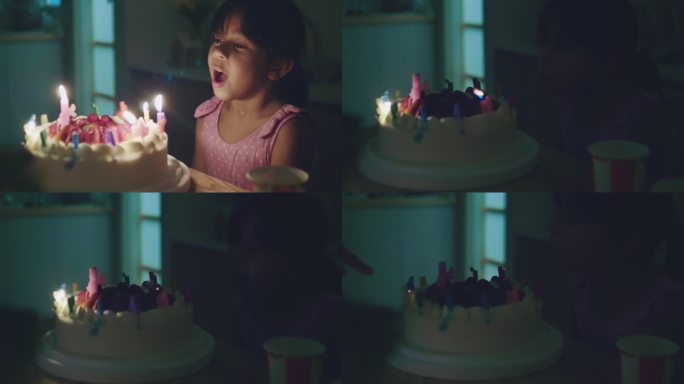 快乐女孩在生日蛋糕上吹蜡烛