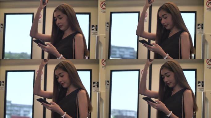 亚洲女性在地铁列车上使用手机