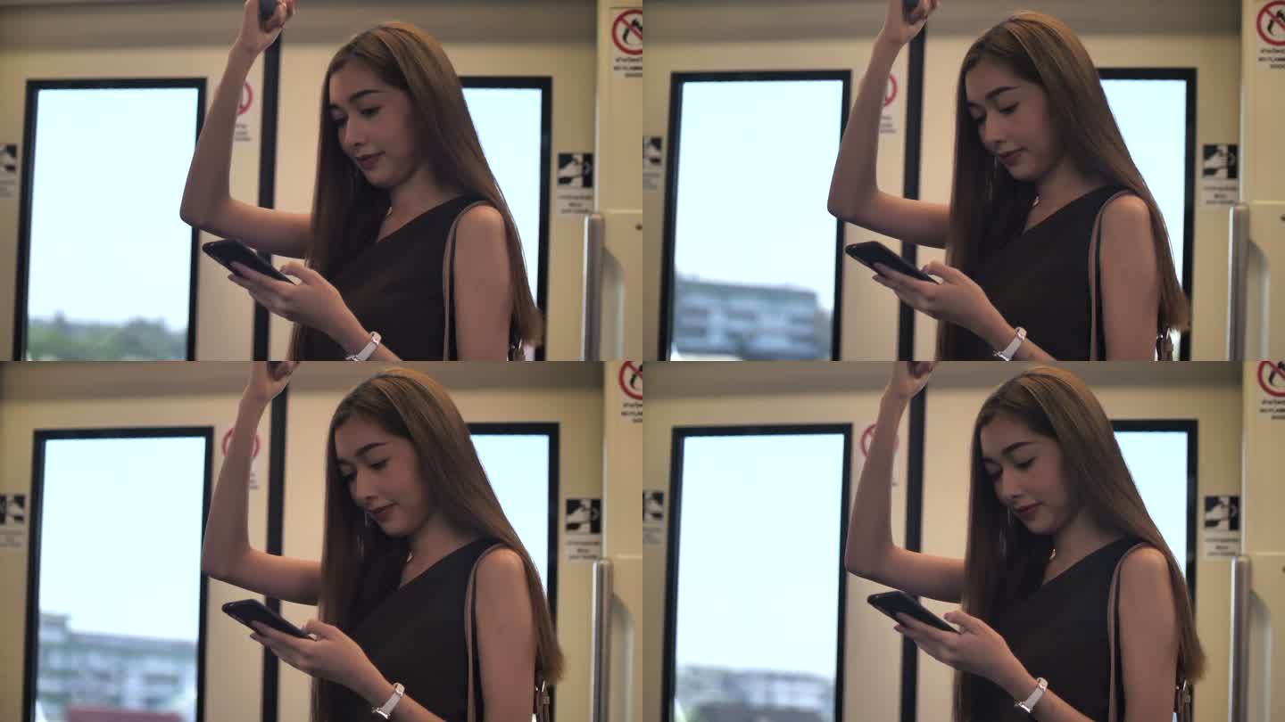 亚洲女性在地铁列车上使用手机
