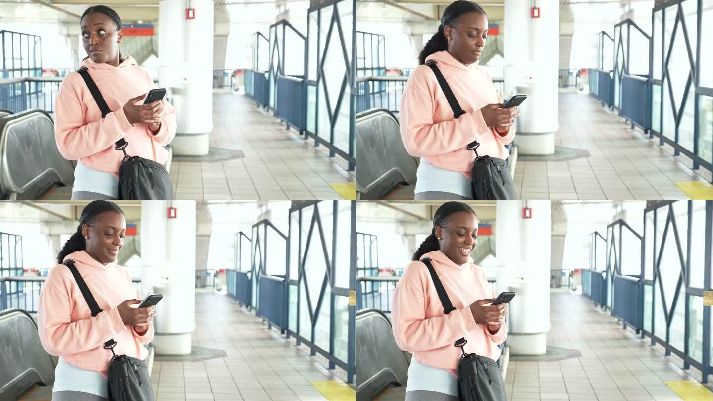 非洲裔美国女子用手机等火车